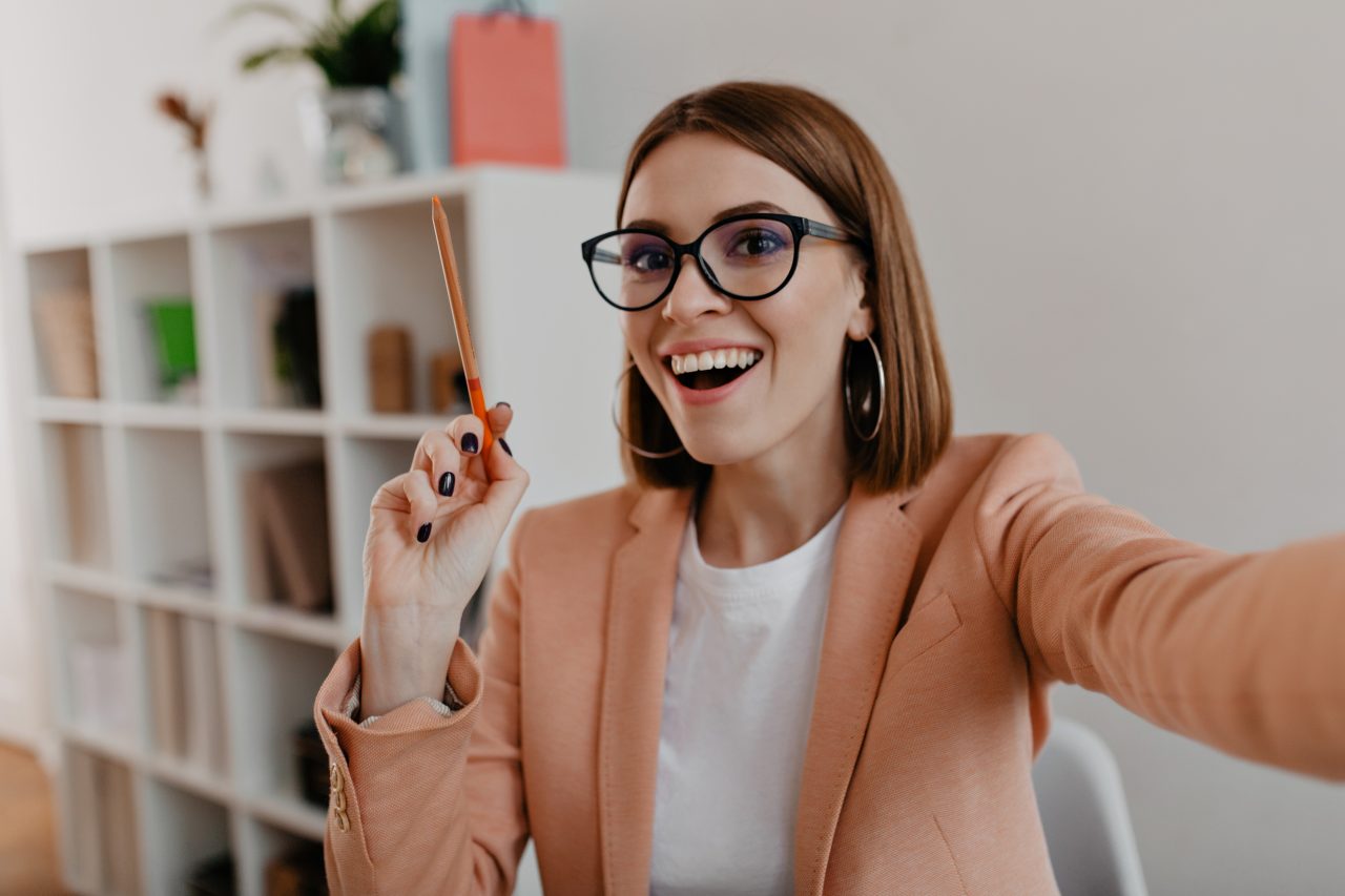 http://ecaterinamoga.com/wp-content/uploads/2021/03/business-lady-with-glasses-stylish-light-outfit-makes-selfie-holding-orange-pencil-her-hands-1280x853.jpg